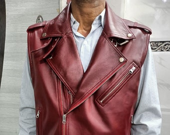 May include: A burgundy leather motorcycle vest with a zipper closure, a belt, and multiple pockets.