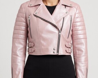 May include: A cropped light pink leather motorcycle jacket featuring a wide notched collar, silver-tone metal zippers, and two adjustable side buckles at the waist. The sleeves have horizontal quilted padding details and zippered cuffs.