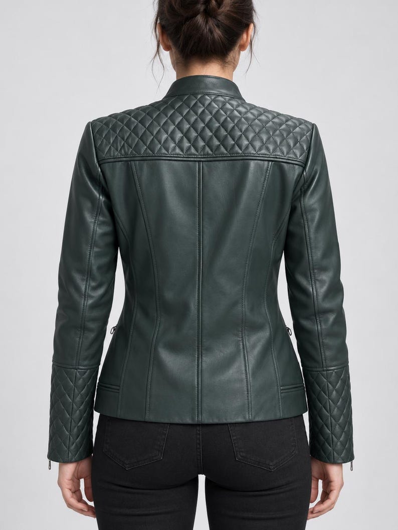May include: A dark forest green jacket featuring a mandarin collar, long sleeves, and a quilted diamond pattern on the upper back shoulders and lower sleeves. The jacket has a smooth finish on the main body panels and vertical seam detailing.