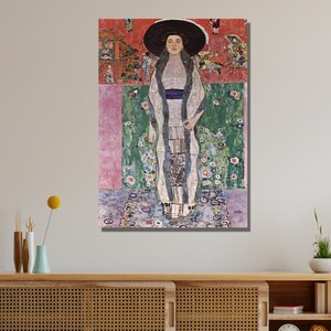 May include: A painting of a woman in a white dress and a black hat standing in a garden setting. The background is a colorful abstract design with flowers and geometric shapes.