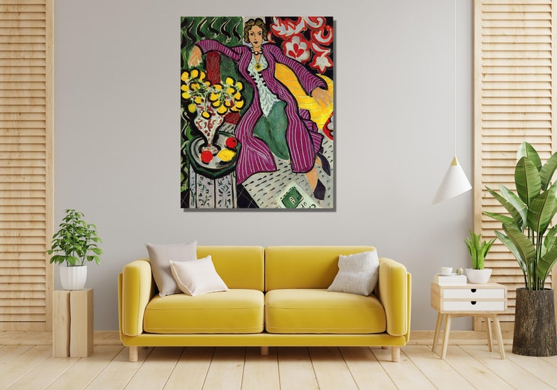 May include: A painting of a woman in a purple and white striped robe sitting in a yellow chair. The woman is wearing a gold necklace and has her hair pulled back. There are yellow lemons and red apples in a vase on a table in the background.