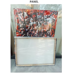 May include: A white canvas panel wrapped in plastic, ready for painting. The panel is sitting on top of a larger canvas with an abstract painting of black and red lines.