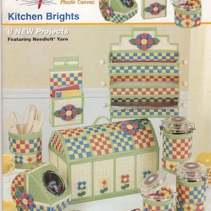 May include: A Quick Count Plastic Canvas Projects Kitchen Brights instructional booklet featuring 8 projects made with Needloft yarn. The cover displays various plastic canvas kitchen accessories including a bread box, canisters, and wall organizers with checkered patterns and floral accents.