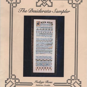 May include: A printed pattern sheet titled The Desiderata Sampler by Indigo Rose and Catherine Strickler. It features a central rectangular image of a cross-stitch sampler with black text and geometric borders on a cream background with black lines.
