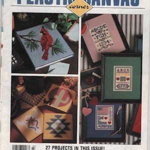 May include: A March 1992 Leisure Arts publication titled Plastic Canvas Corner featuring 27 projects. The cover displays various plastic canvas crafts including a cardinal, alphabet samplers, coasters, and a framed God Bless America needlepoint.