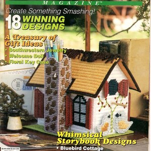 May include: Plastic Canvas! Magazine Number 21 featuring a craft project of a white cottage with a brown roof, a tall chimney, and two bird figures on the front. The cover includes text such as Create Something Smashing! and 18 Winning Designs.