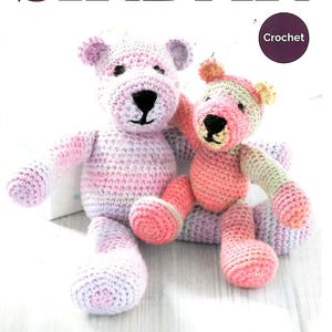 May include: Two crocheted teddy bears in shades of pink, purple, and white. The larger bear sits next to a smaller one. The word "SIRDAR" is at the top, with "Crochet" in a circle. The text "Snuggly Rascal DK" is at the bottom.