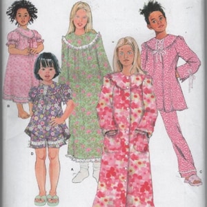 May include: Simplicity 1571 sewing pattern for children's sleepwear in sizes 3-6. The envelope displays illustrations of five different pajama styles, including nightgowns, a robe, and a pajama set with floral and animal print patterns.