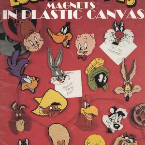 May include: A Leisure Arts craft leaflet titled Looney Tunes Magnets in Plastic Canvas, featuring various Looney Tunes character designs stitched in plastic canvas, including Bugs Bunny, Daffy Duck, Tweety Bird, and the Tasmanian Devil.