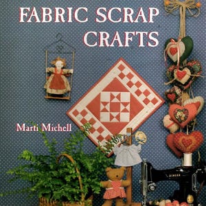 May include: A book cover titled "COUNTRY FABRIC SCRAP CRAFTS" with a blue polka dot background. The cover features a quilt block, hanging hearts, a doll in a swing, a teddy bear, a sewing machine, and a basket of greenery.