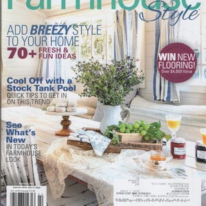 May include: A CountrySampler Farmhouse Style magazine cover featuring the text 35+ DIY Projects, 70+ Fresh & Fun Ideas, and Win New Flooring. The cover displays a white wooden table with a bouquet of purple flowers, green grapes, and jars.