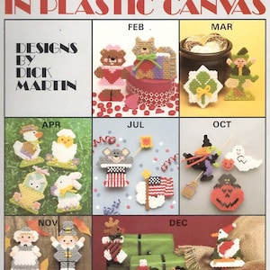 May include: A Leisure Arts craft leaflet 1138 titled More Holiday Magnets in Plastic Canvas, featuring designs by Dick Martin. The cover displays various seasonal plastic canvas magnet projects for months including February, March, April, July, October, November, and December.