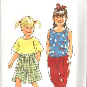 May include: A sewing pattern for children's clothing, featuring two girls wearing different outfits. The pattern is called "It's So Easy it's Simplicity" and the number is 7709. The size is 3-8.