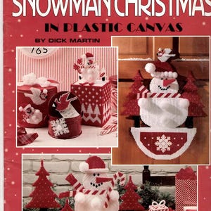 May include: A Leisure Arts craft leaflet titled Snowman Christmas in Plastic Canvas by Dick Martin. The cover features photographs of various plastic canvas projects including snowmen, Christmas trees, and gift boxes in red and white.