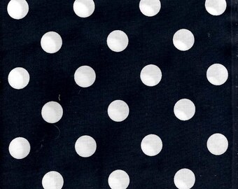 May include: Black fabric with a white polka dot pattern. A wooden ruler with inch markings is placed at the bottom of the image.