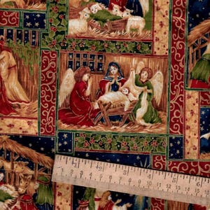 May include: Fabric with a repeating pattern depicting scenes from the Nativity. The fabric features angels, the baby Jesus, and other figures in a colorful, detailed design. The background is a mix of blue, green, and gold.