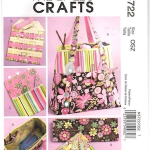 May include: McCall's Crafts M5722 sewing pattern envelope featuring illustrations of a tote bag, a folding organizer, and a small pouch. The designs showcase floral and striped fabric patterns in shades of pink, brown, green, and yellow.