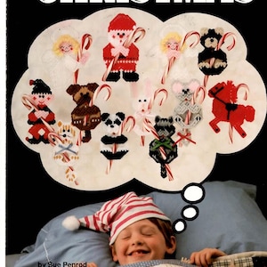 May include: A craft pattern book titled Candy Cane Christmas featuring 12 plastic canvas ornaments. The cover displays a thought bubble containing various stitched figures like Santa, animals, and angels, each holding a candy cane.