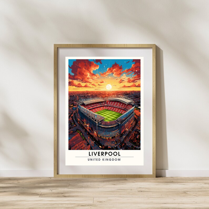May include: An illustration of Anfield Stadium in Liverpool, England, with a sunset sky in the background. The stadium is a large, oval-shaped structure with a green field and red seats. The text "LIVERPOOL" and "UNITED KINGDOM" is printed below the stadium.