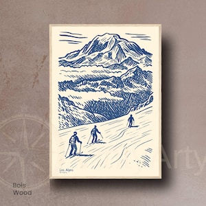 May include: A framed print with a blue and cream illustration of a mountain scene with skiers. The artwork includes the text "Les Alpes" and "Bois Wood". The style is reminiscent of a woodcut.