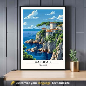 May include: A vintage travel poster featuring a scenic view of Cap-d'Ail, France. The poster depicts a picturesque coastal town with colorful buildings perched on a cliff overlooking the azure Mediterranean Sea. Lush greenery and a clear blue sky complete the idyllic scene.
