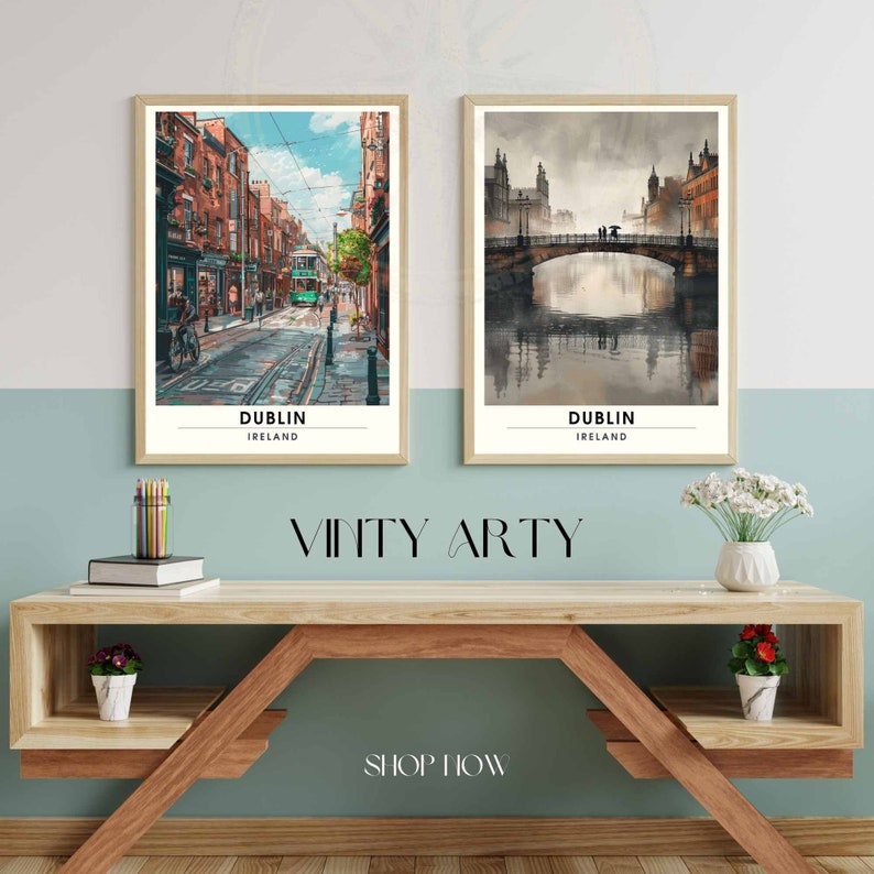 May include: Two framed art prints of Dublin, Ireland, displayed on a wooden shelf. One print shows a street scene with a green tram, the other a bridge over water. The prints are in a watercolour style. The text "Dublin Ireland" is at the bottom of each print.