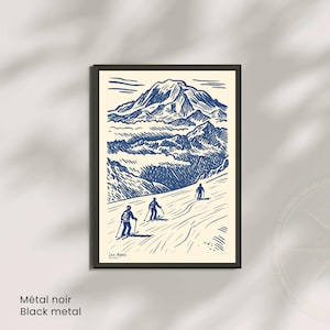 May include: A framed print with a blue and white illustration of a mountain range and three skiers. The words "Les Alpes" are in the lower left corner. The frame is black, and the text "M&eacute;tal noir Black metal" is at the bottom.