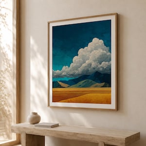May include: A square framed wall art print featuring a landscape painting of a golden wheat field in the foreground, dark blue mountains in the middle ground, and a large, voluminous white cloud formation set against a deep teal sky.