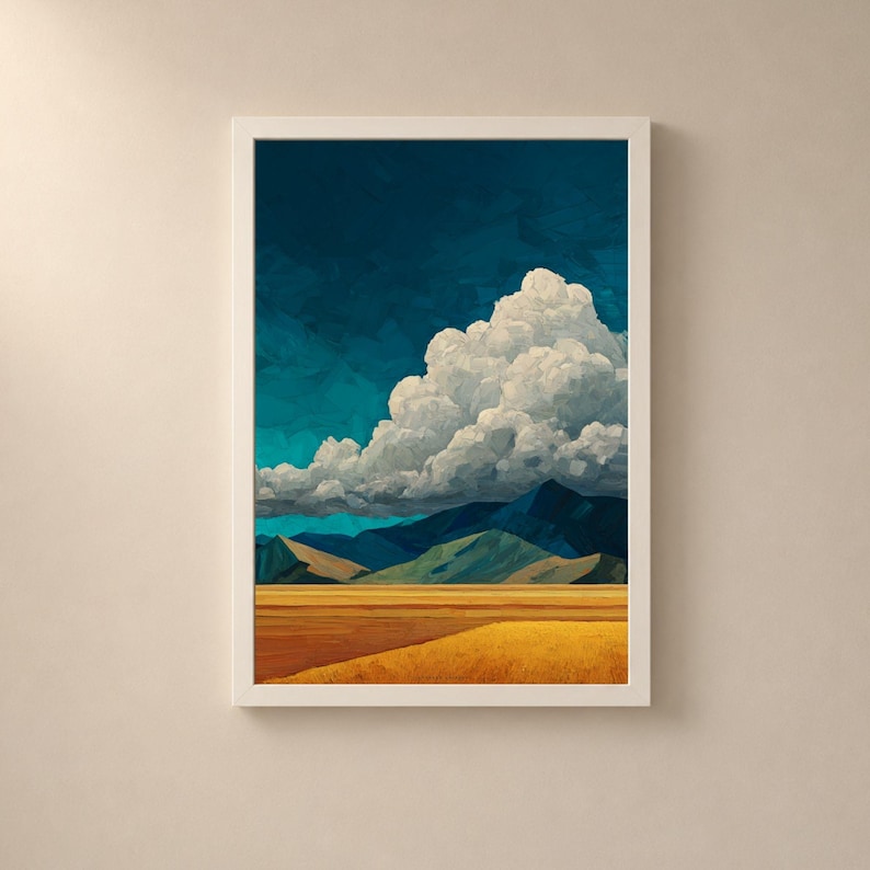 May include: A framed wall art print featuring a landscape with a golden yellow field in the foreground, dark blue and green mountains in the mid-ground, and a large, textured white cloud formation set against a deep navy blue sky.