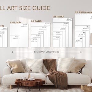 May include: A wall art size guide shows print dimensions, including 28x36 cm, 46x61 cm, and 61x91 cm sizes. The guide is displayed above a sofa that is 228cm wide. The text "WALL ART SIZE GUIDE" is at the top.