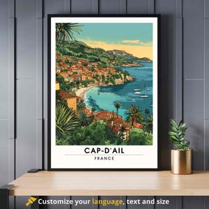May include: A colorful illustration of Cap-d'Ail, France, a coastal town with a beach and buildings on a hillside. The illustration is in a vintage travel poster style.