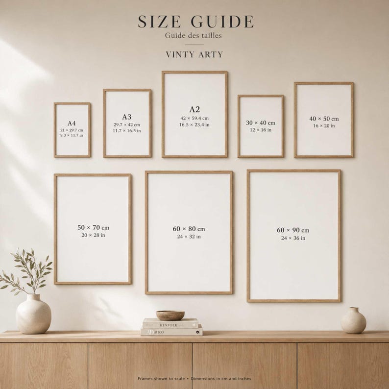May include: A size guide chart titled VINTY ARTY displaying nine rectangular frames in various sizes, labeled with dimensions in both centimeters and inches, ranging from A4 to 60 by 90 cm, arranged on a wall above a wooden surface.