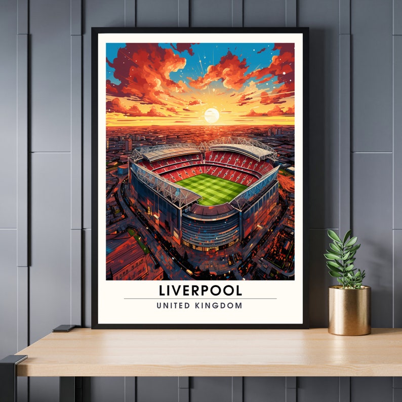 May include: An illustration of Anfield Stadium in Liverpool, England, with a sunset sky in the background. The stadium is red and white with a green field. The text "LIVERPOOL" and "UNITED KINGDOM" is below the stadium.