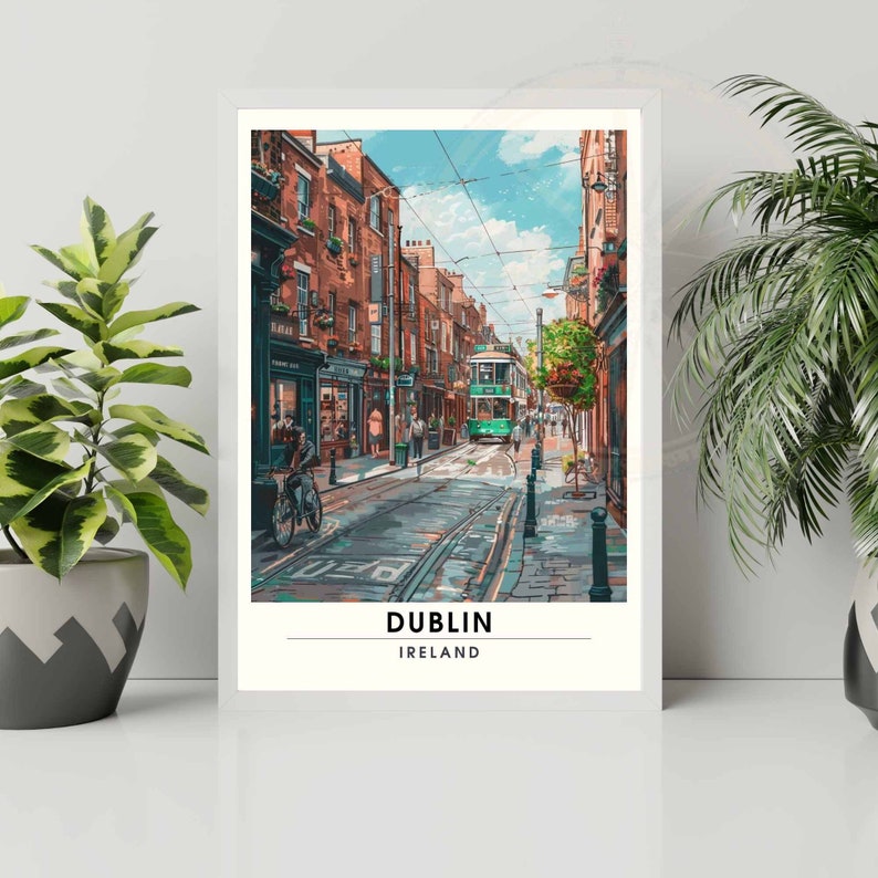 May include: A framed art print showing a street scene in Dublin. The image features a green tram, buildings with shops, and people. The print has a white border and the text "DUBLIN IRELAND" at the bottom.