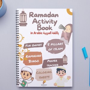 Może przedstawiać: Biała książka z ćwiczeniami z kolorową okładką przedstawiającą ilustracje dzieci i zajęć związanych z Ramadanem. Tytuł to "Ramadan Activity Book" w języku angielskim i arabskim. Książka zawiera takie zajęcia jak: gry, 5 filar&oacute;w islamu, bingo ramadanu, śledzenie modlitw i kolorowanki.