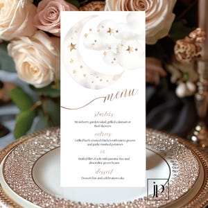 May include: A white menu card with a gold crescent moon and clouds design. The menu features a list of starters, entrees, and desserts. The text "menu" is written in cursive.