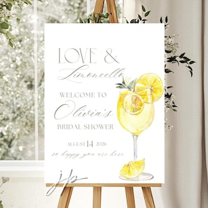May include: A white sign on a wooden easel with the text "LOVE & Limoncello" and "Welcome to Olivia's Bridal Shower". A watercolor illustration of a limoncello drink with lemon slices is featured. The date August 14, 2026 is also displayed.