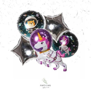 May include: A set of six foil balloons featuring a unicorn astronaut, a bear astronaut, and silver stars. The unicorn astronaut balloon is large and has a purple helmet. The bear astronaut balloon is round and has a black helmet. The silver stars are foil balloons.