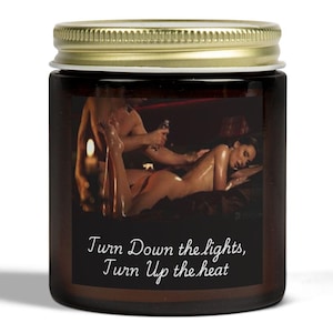 May include: A brown glass jar with a gold lid. The jar has a label with a photo of a couple in bed and the text "Turn Down the lights, Turn Up the heat".