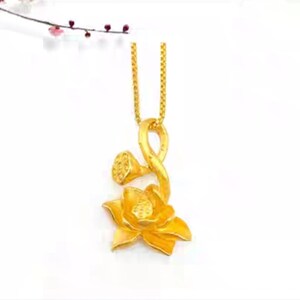 May include: A gold pendant necklace featuring a lotus flower design. The pendant is made of a single piece of gold and has a delicate, intricate design.