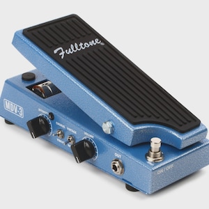 May include: A blue Fulltone MDV-3 guitar effects pedal with a black footpad. The pedal has several knobs and switches for adjusting the sound, including intensity, chorus, vintage, and volume. The pedal has an on/off switch and an output jack.