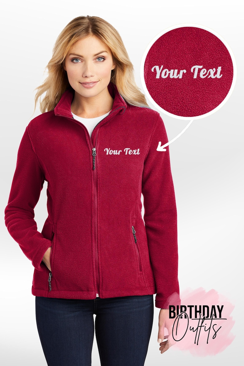 May include: A red fleece jacket with a zipper closure and two pockets. The jacket has "Your Text" embroidered on the left chest and right sleeve.