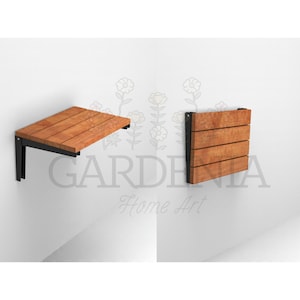 May include: A wooden folding wall-mounted table with black metal brackets. The table is folded up against the wall and is made of light brown wood.