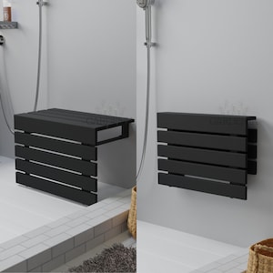 May include: A black, wall-mounted shower bench with a slatted design. The bench is shown in both the open and folded positions, offering a space-saving solution for the bathroom. The bench is made of wood and has a modern aesthetic.