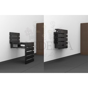 May include: A black wooden folding wall-mounted chair with a seat and back. The chair is folded up against the wall and is in a closed position. The chair is made of wood slats and has a simple design.