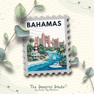 May include: A postage stamp-shaped art print featuring the word BAHAMAS in dark blue text. The illustration depicts a pink resort building, a red and white lighthouse, palm trees, a sailboat, and a motorboat on blue water. The Sunprint Studio logo is below.