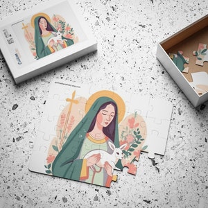 May include: A white jigsaw puzzle with a colorful illustration of a woman holding a white lamb. The woman is wearing a green robe and a yellow halo. The puzzle is set against a white background.