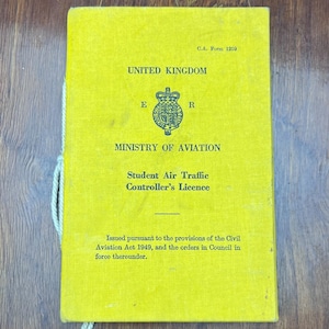 May include: A bright yellow rectangular document titled United Kingdom Ministry of Aviation Student Air Traffic Controller's Licence. The cover features a royal crest, the text C.A. Form 1259, and legal text regarding the Civil Aviation Act 1949.