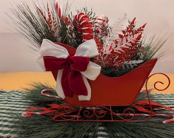 Christmas red sleigh with candy canes and peppermints table centerpiece