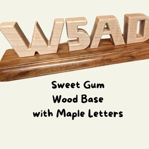 Blonde Maple wooden carved block-style letters "W5AD", they are a ham radio call sign. The base has a dark rich grain giving it a polished, professional look. The wood is sweet gum and is finished with Danish Oil.